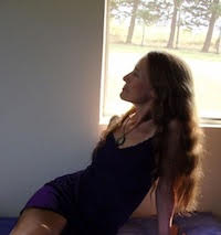 Deva leaning back in sunlit room