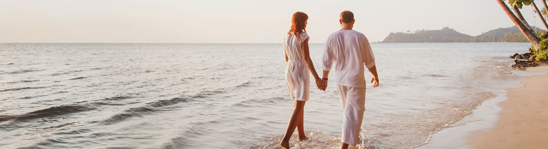 Romantic couple takes a stroll on the beach